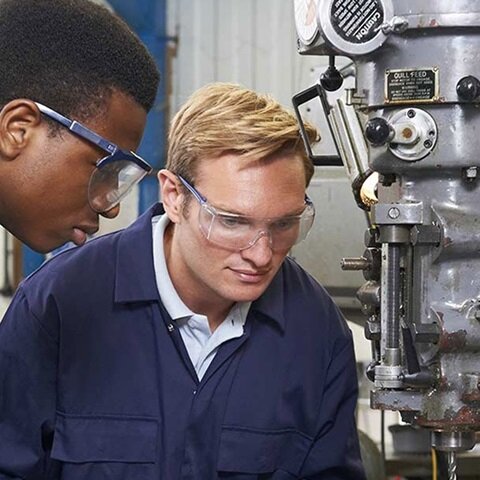 two people operating machinery